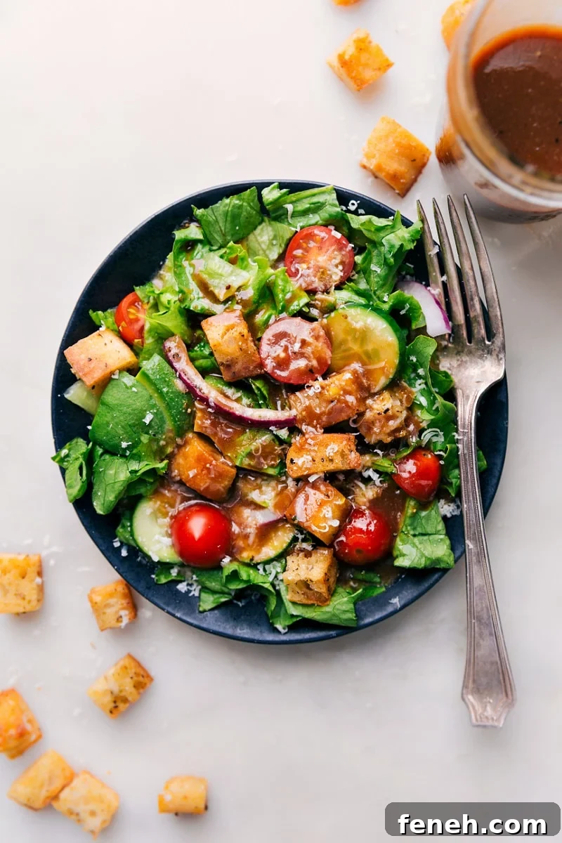This simple Balsamic Vinaigrette takes mere minutes to whip together and no special kitchen appliances needed! This tangy vinaigrette has nicely balanced flavors and a great thickness -- the perfect topping for a simple side salad, garden salad, or topping on roasted vegetables! Overhead image of the Balsamic Vinaigrette on a salad