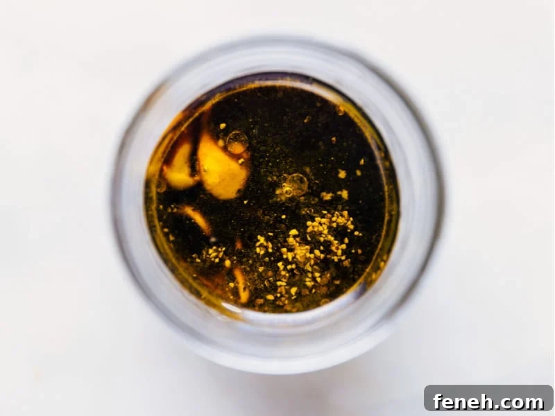 This simple Balsamic Vinaigrette takes mere minutes to whip together and no special kitchen appliances needed! Overhead image of the dressing with all the ingredients added