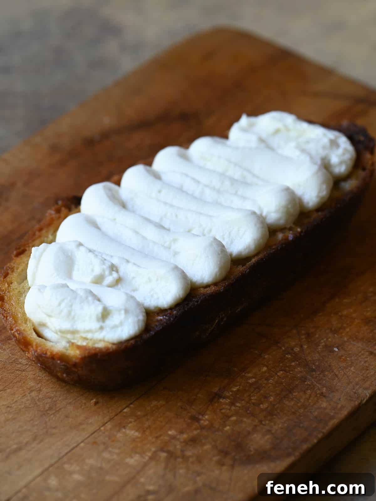 Ricotta toast on a cutting board.