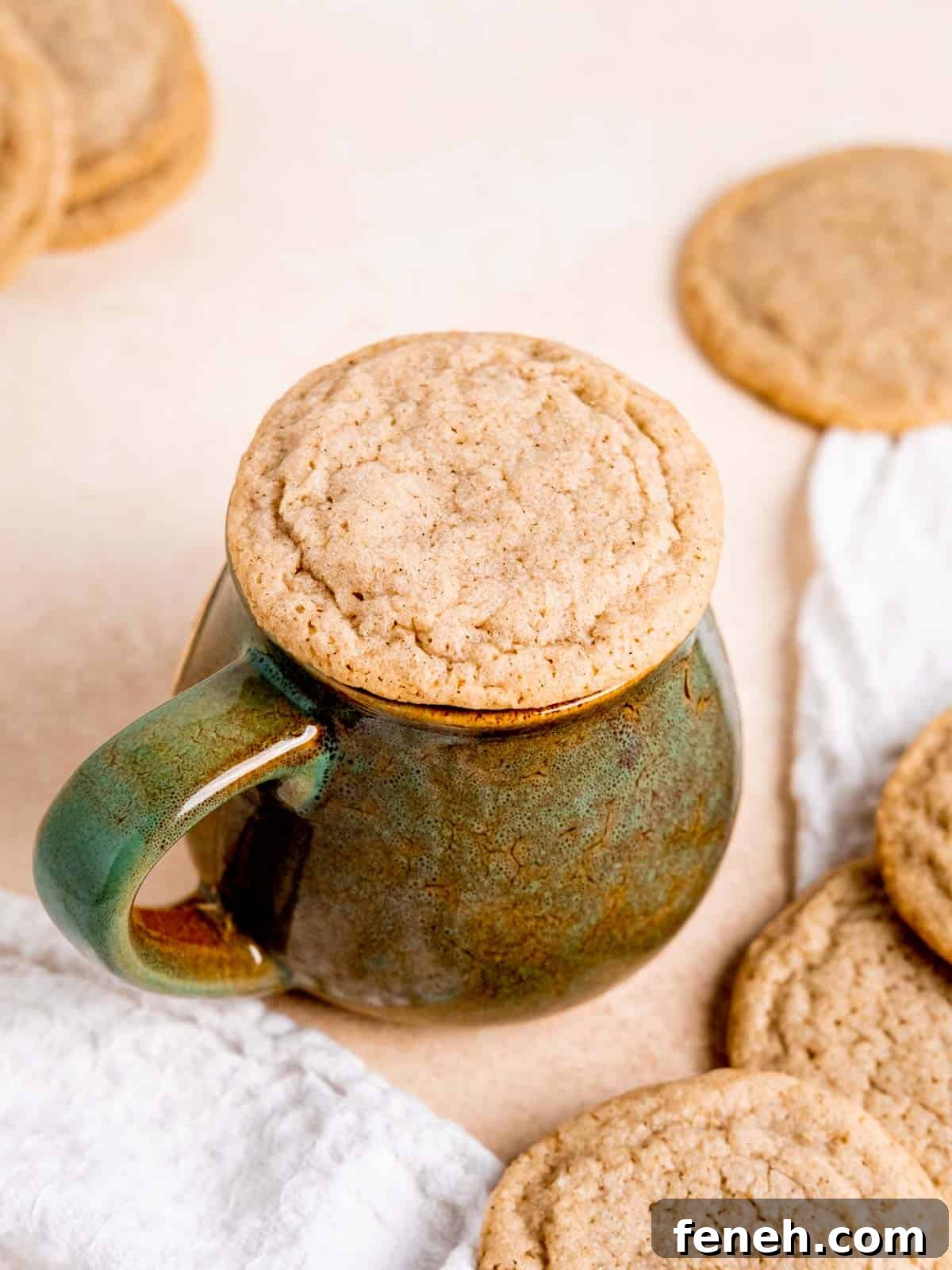 A chai cookie sitting on top of a coffee mug.