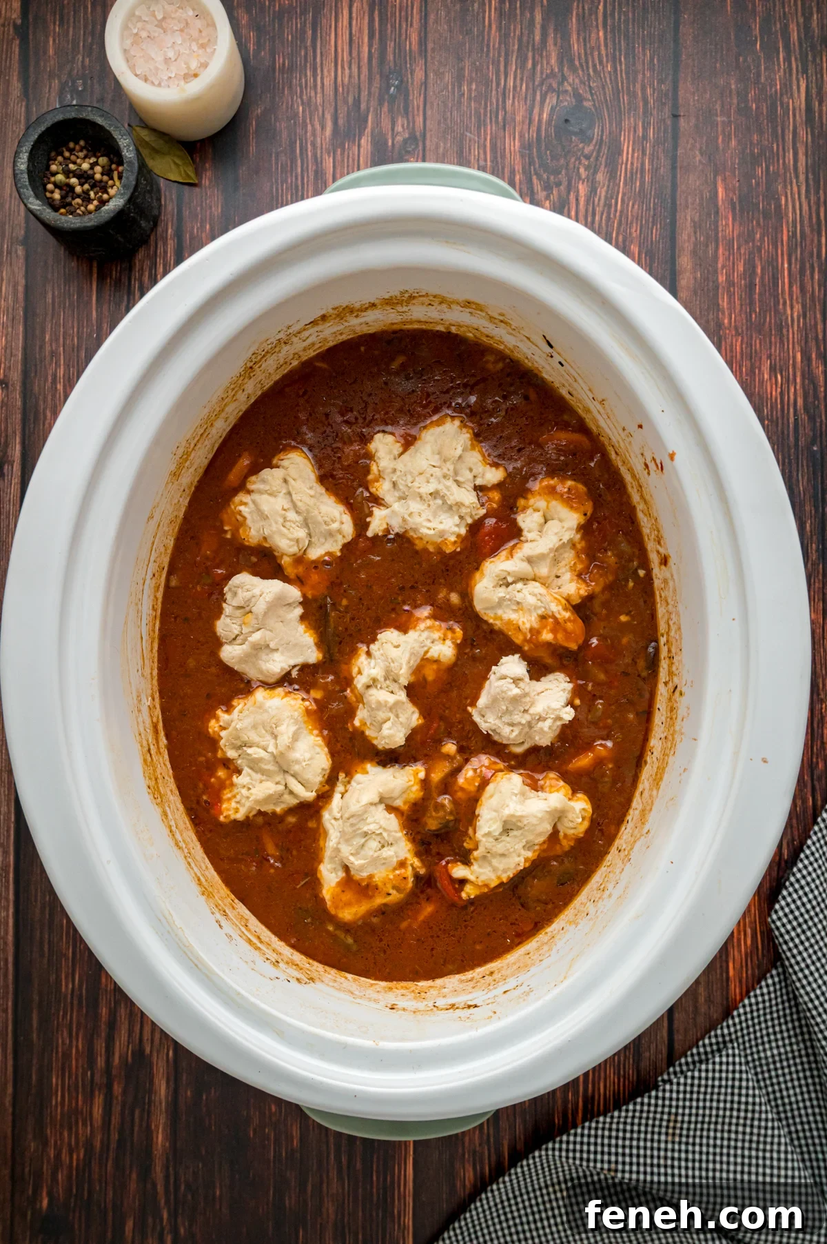 Hearty Beef Stew with Fluffy Dumplings Recipe 6 Raw dumplings added on top of beef stew in a crockpot.