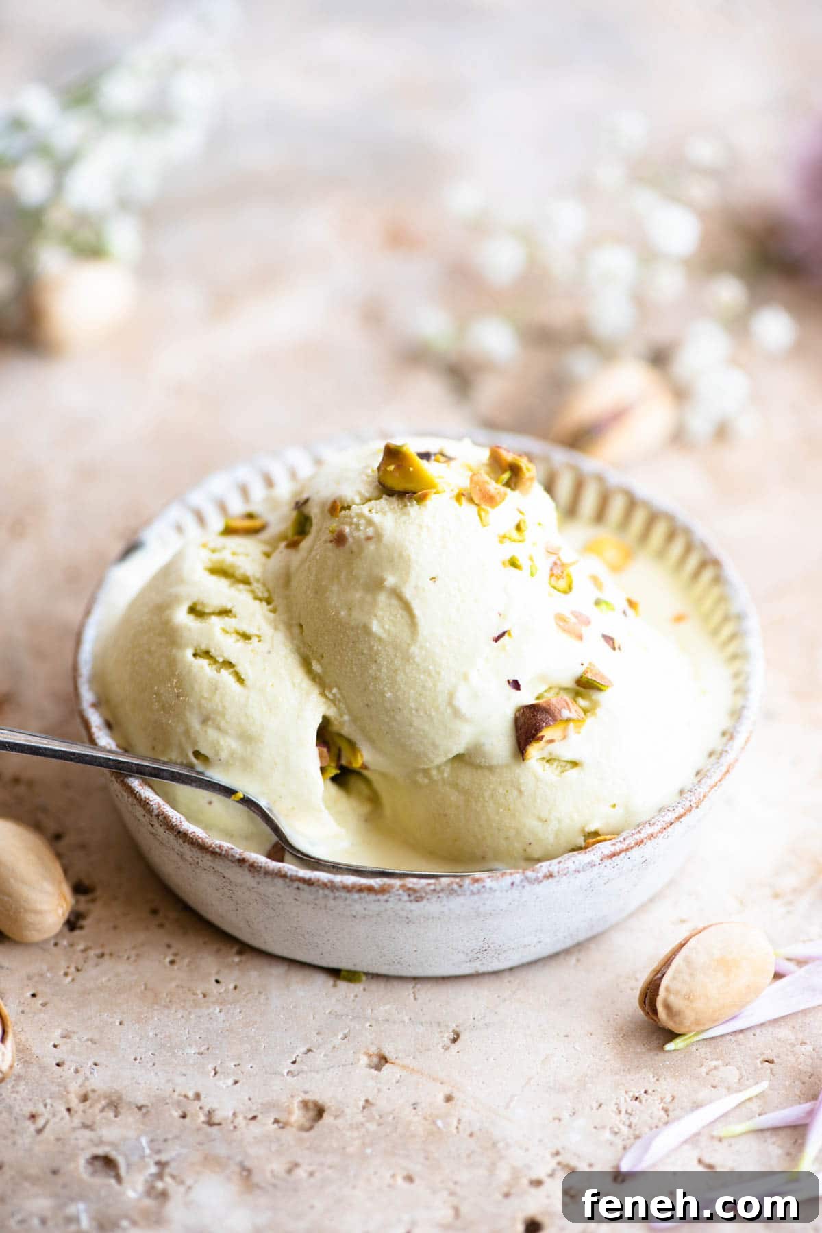 Three scoops of pistachio ice cream in a rustic looking ramekin