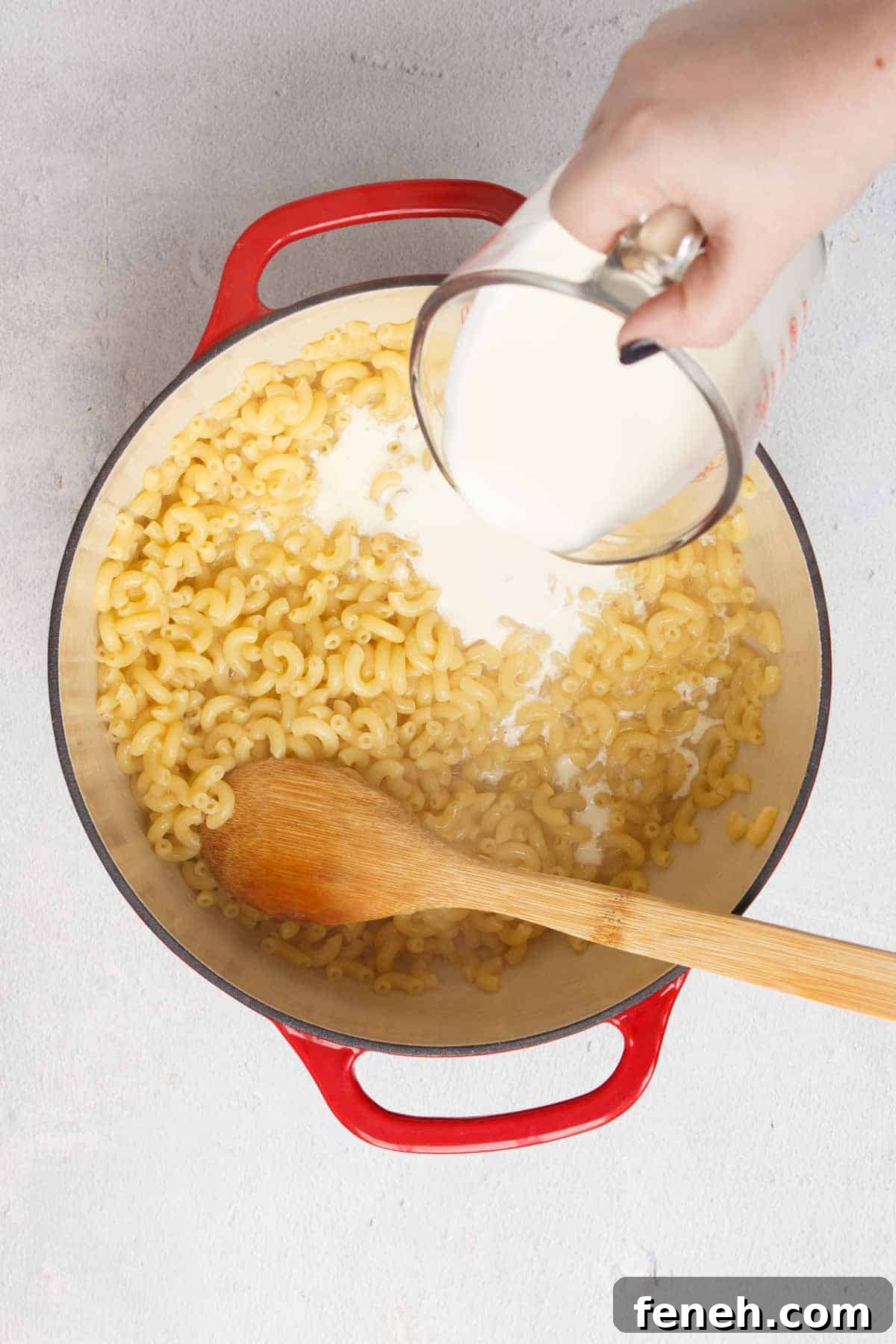 Pouring heavy whipping cream into the pot