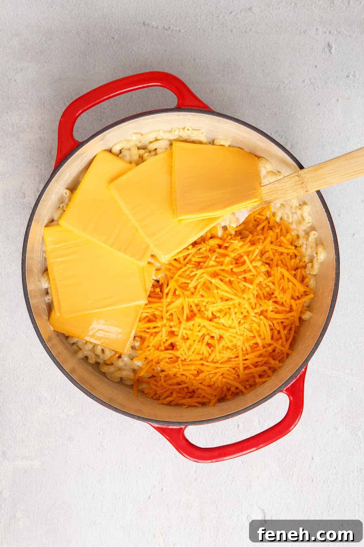 Adding cheddar and American cheese to the pot