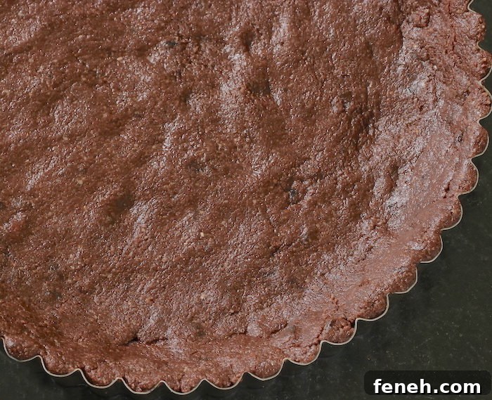 Cacao crust pressed into a tart pan