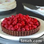 Fresh Raspberry Tart served on a white plate