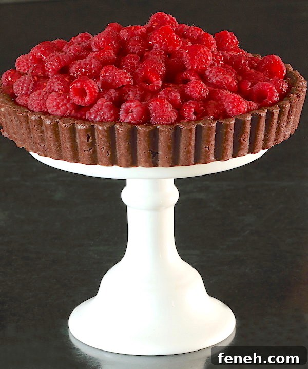 Fresh Raspberry Tart on a white pedestal