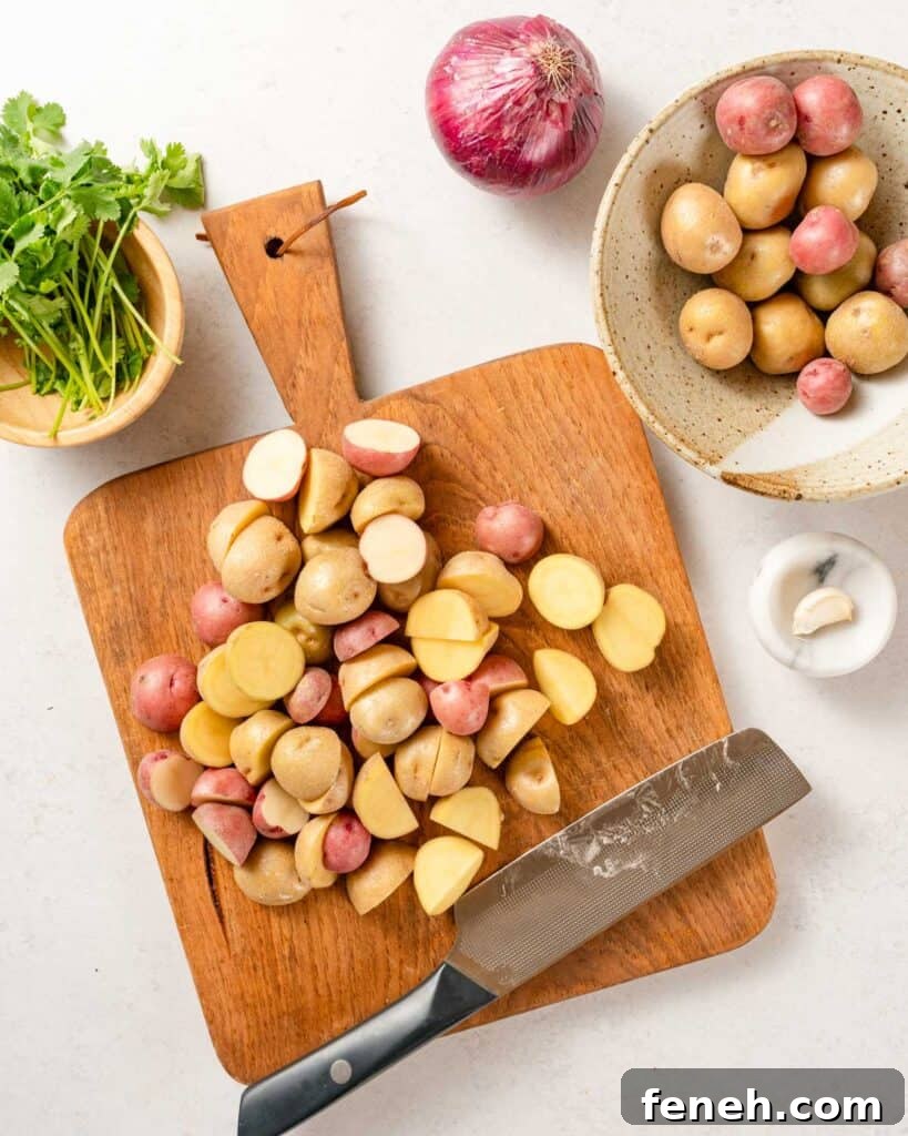 baby potatoes cut in half on cutting board.