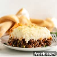 Mashed potatoes on meat filling on a white plate.