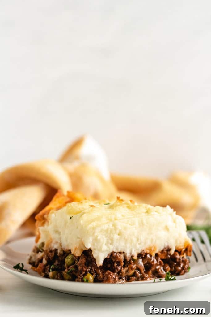 Shepherd's pie with cheesy potatoes on a serving plate.