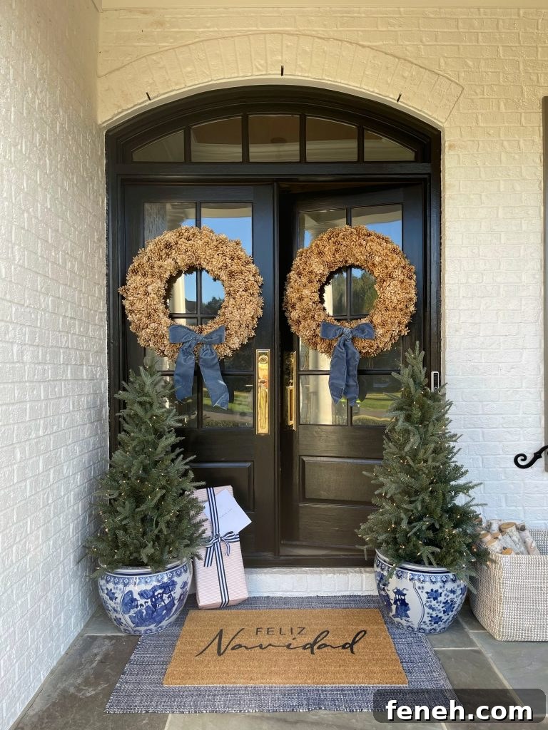 front porch decorated for christmas with pine cone wreaths