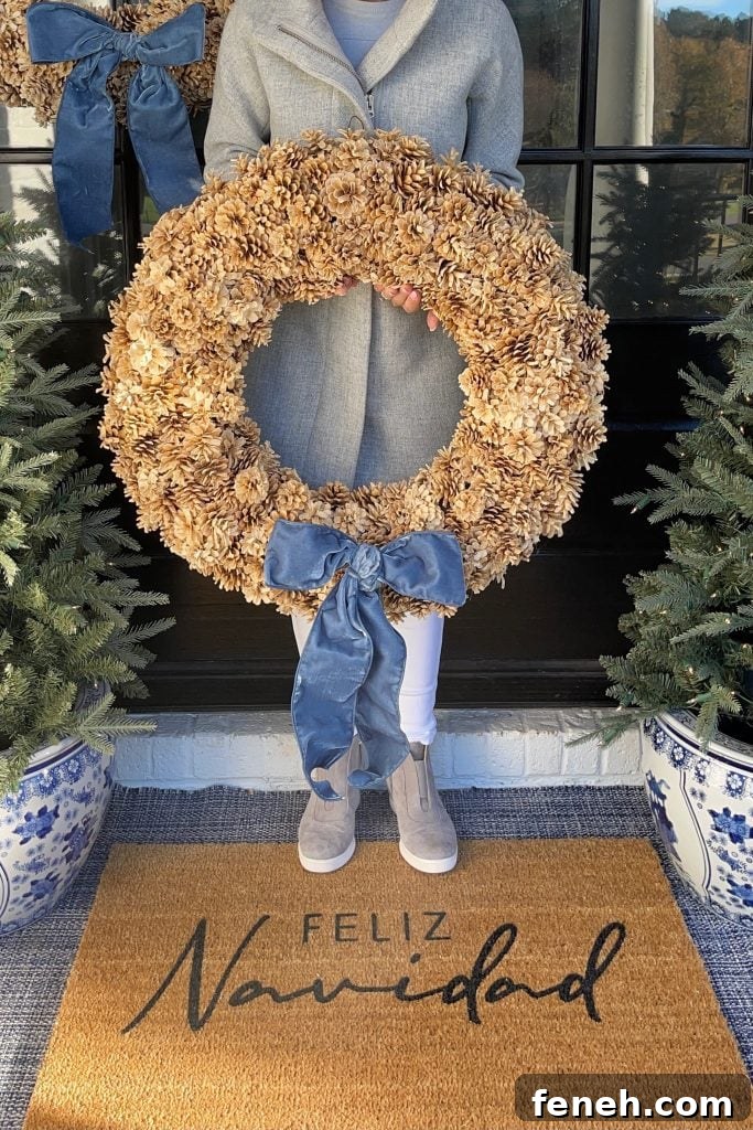 girl holding pinecone wreath from Serena and lily