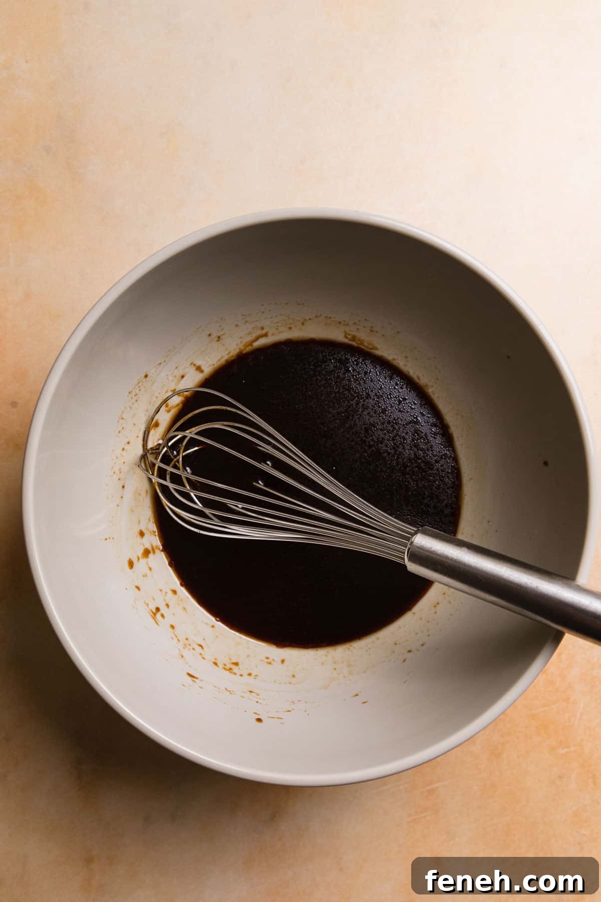 making the sauce with a whisk