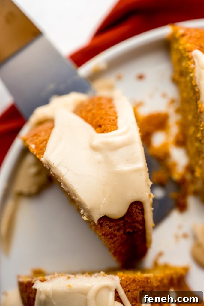 Aerial photo of a slice of pumpkin Bundt cake sitting on a platter.