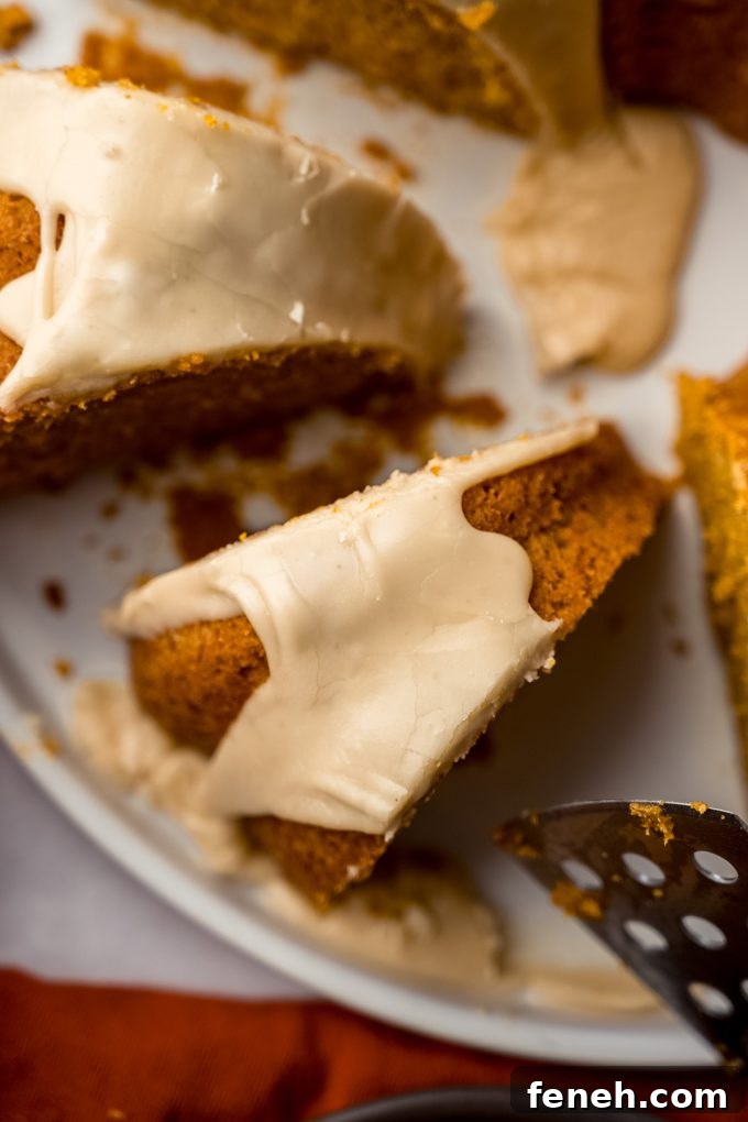 Aerial photo of a slice of pumpkin Bundt cake sitting on a platter.