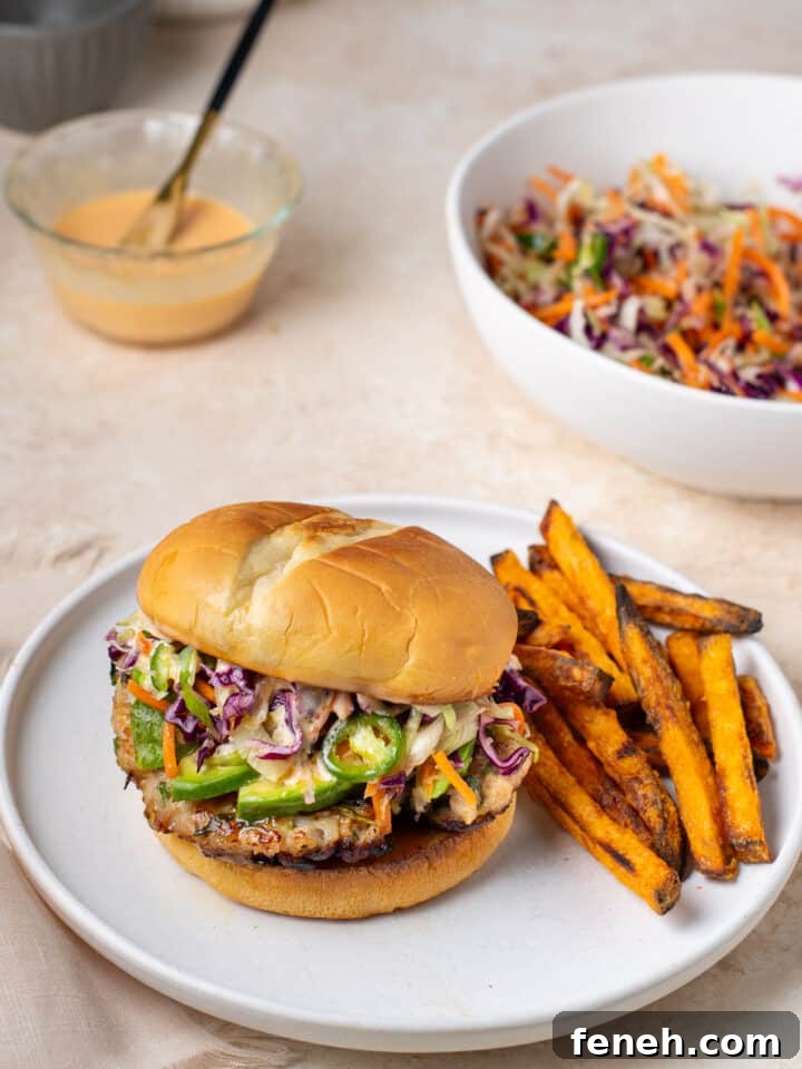 sweet chili ground chicken burger with avocado slices, sesame slaw and sweet potato fries