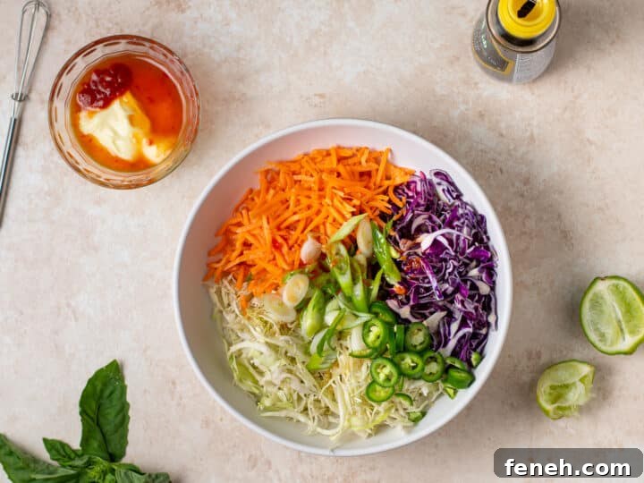 shredded cabbage, carrots, green onions and jalapeños in a bowl before mixing