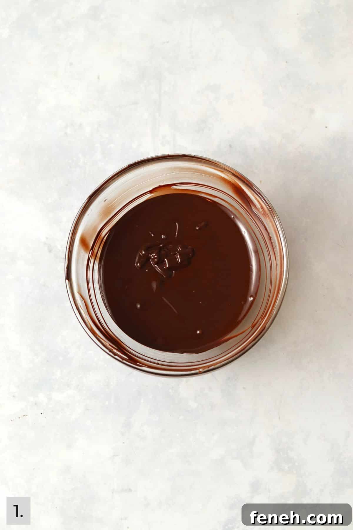 Melted chocolate in a glass bowl.