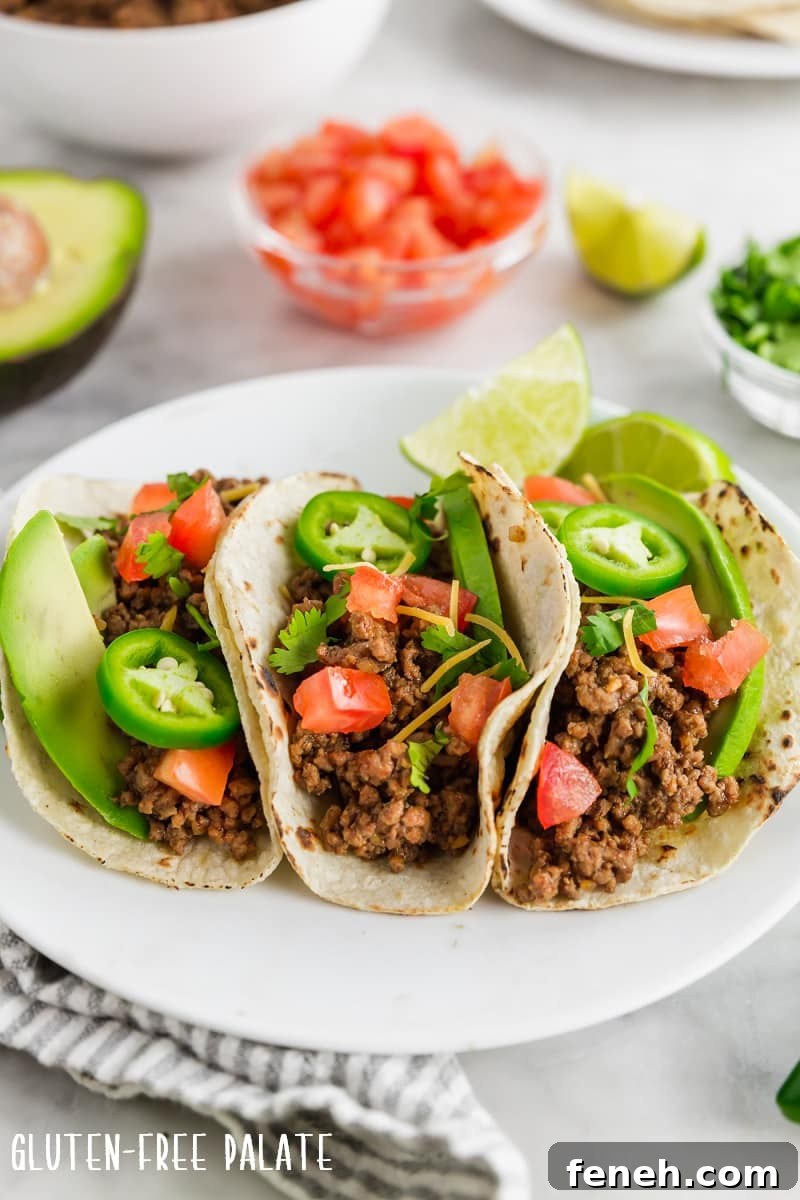 three gluten-free tacos on a white plate.