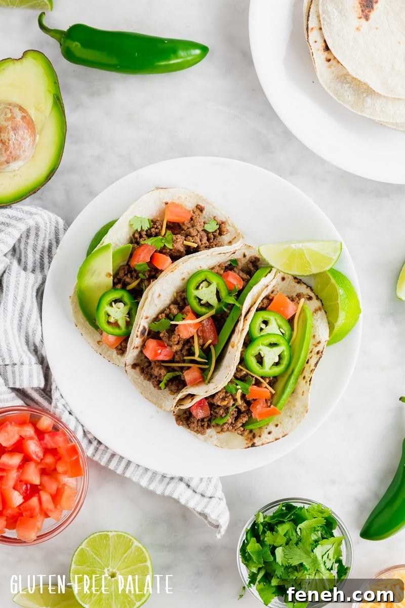 top down view of three gluten-free tacos on a white plate