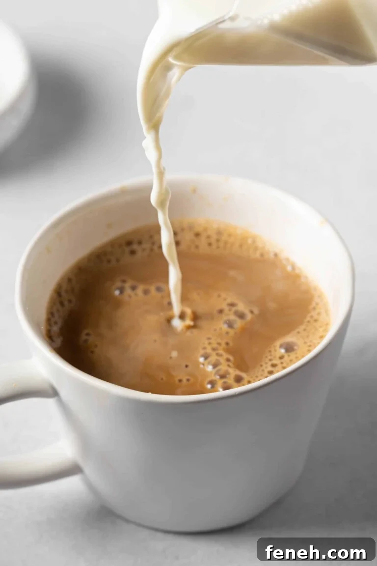 milk pouring into a mug