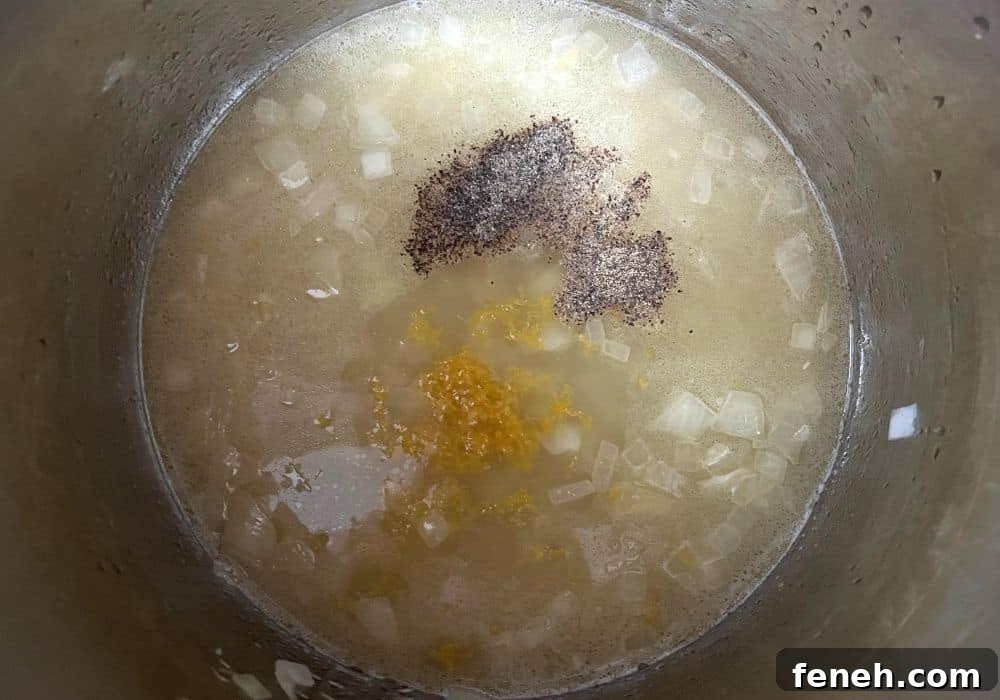 broth, orzo, lemon zest, and black pepper added to the insert pot of the Instant Pot