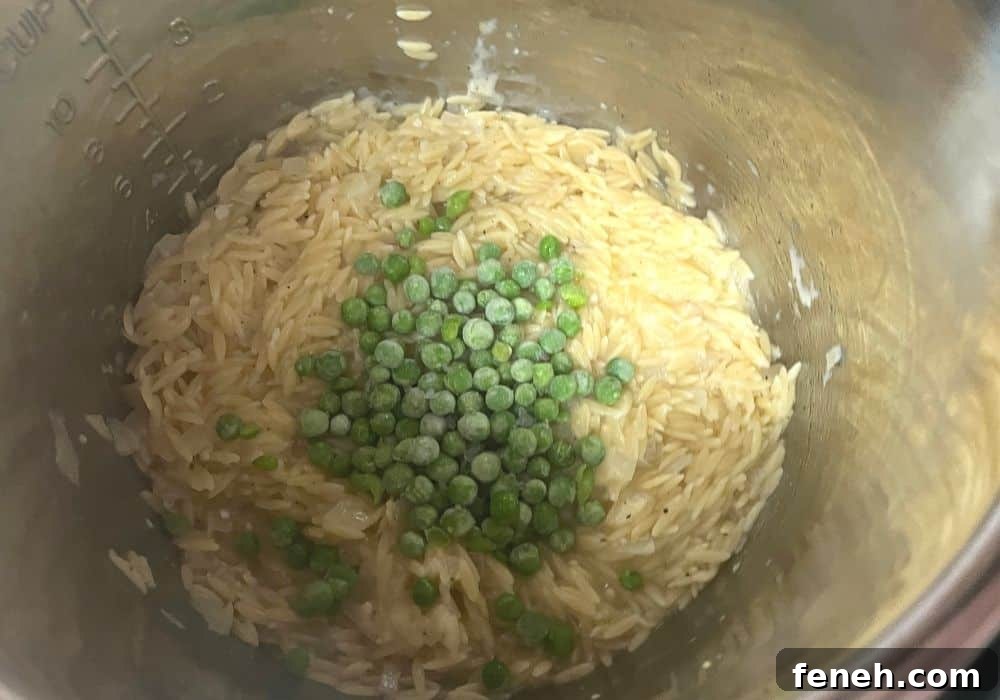 lemon juice and frozen peas added to the cooked orzo in the instant pot