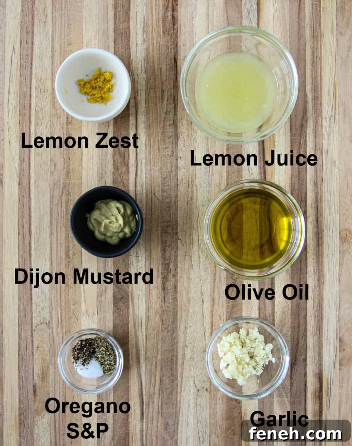 The ingredients for the salad dressing in glass bowls.