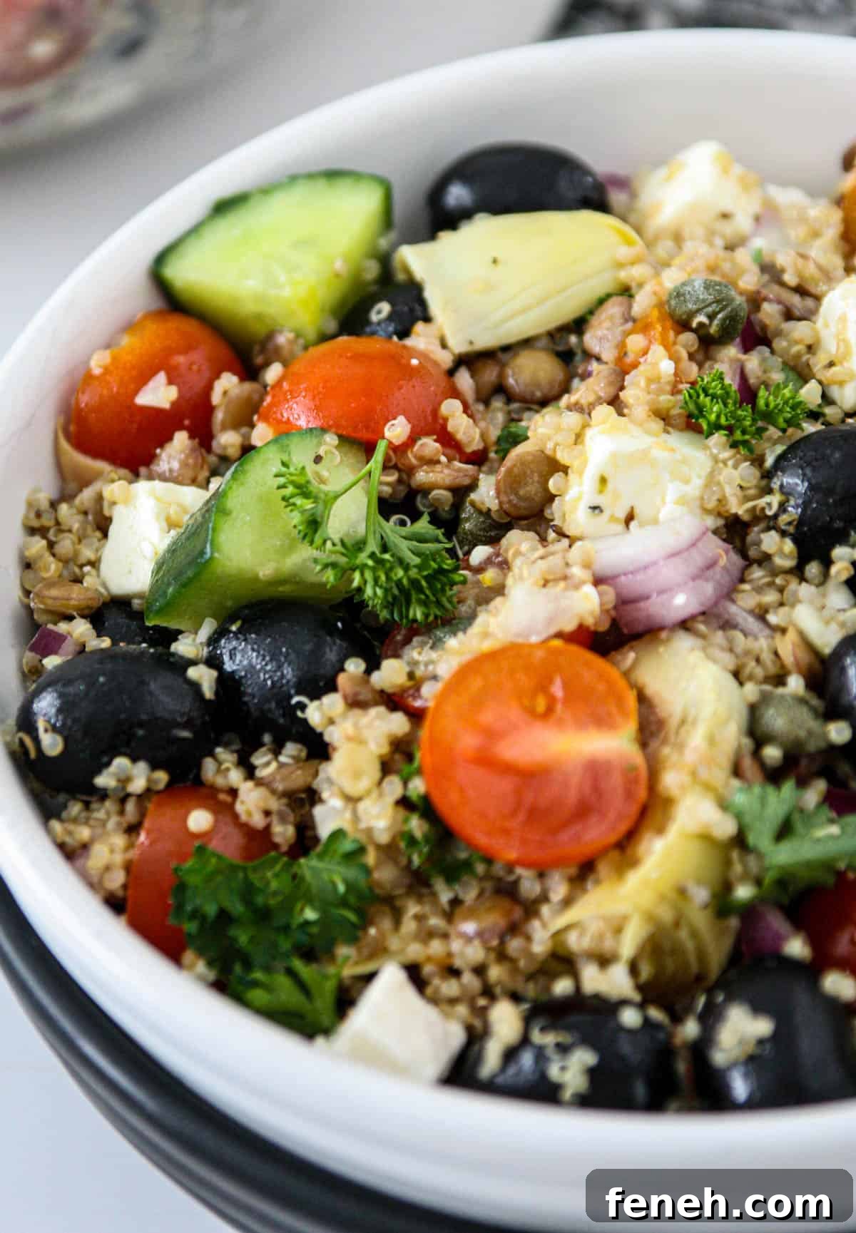 Lentil and quinoa salad in a white bowl.