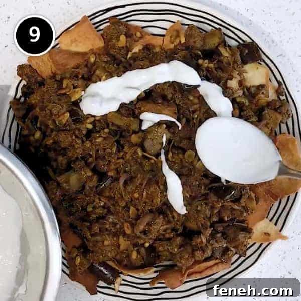 Arranging the lamb fatteh with flatbreads, spiced lamb and eggplant and drizzling yoghurt sauce on a large platter.