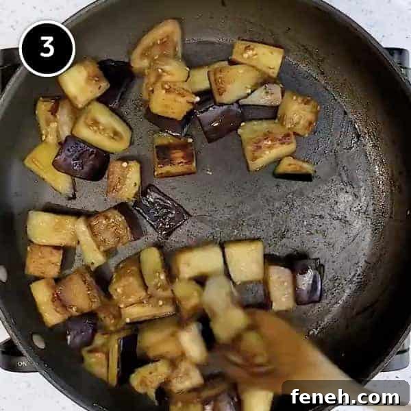 Frying cubes of eggplant in a small pan