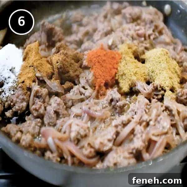 Adding ground spices to ground lamb in a small pan