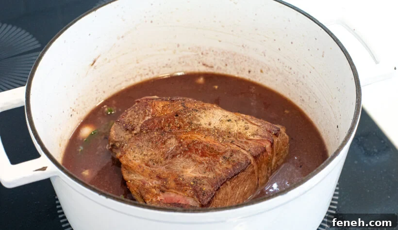 adding beef broth and herbs to the pan