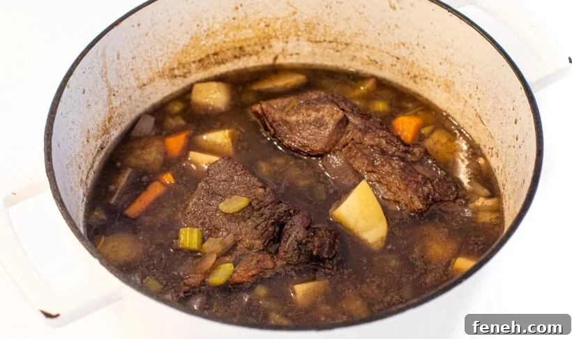 cooked pot roast in large cast iron pot