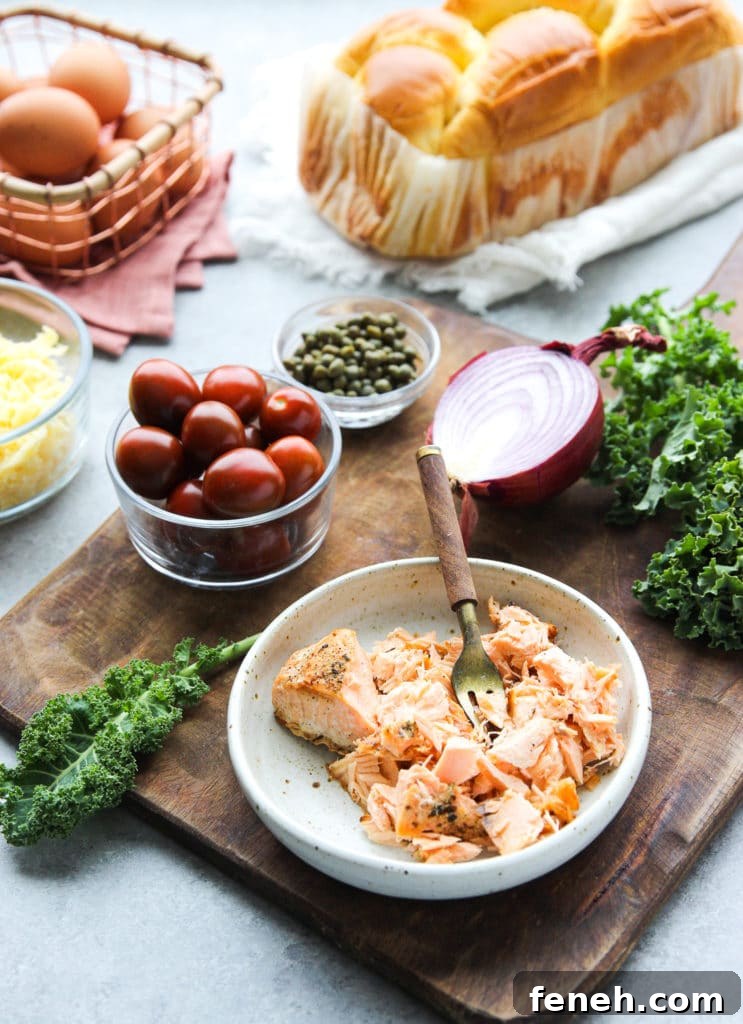 Eggs, brioche bread, shredded salmon, onion, kale and other ingredients to make salmon breakfast casserole