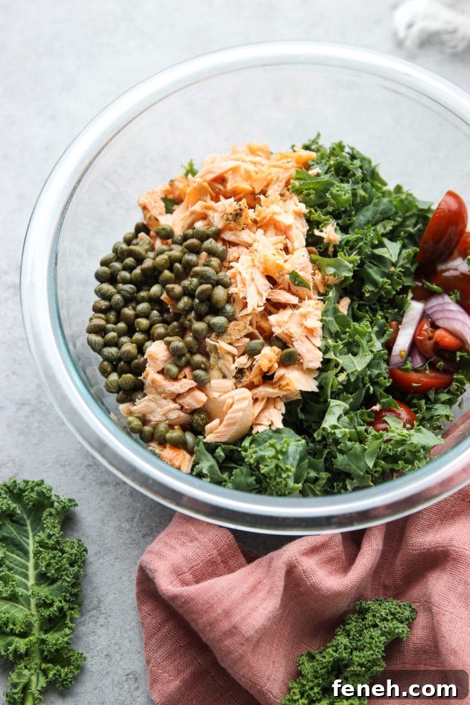 Shredded salmon in another bowl with some vegetables