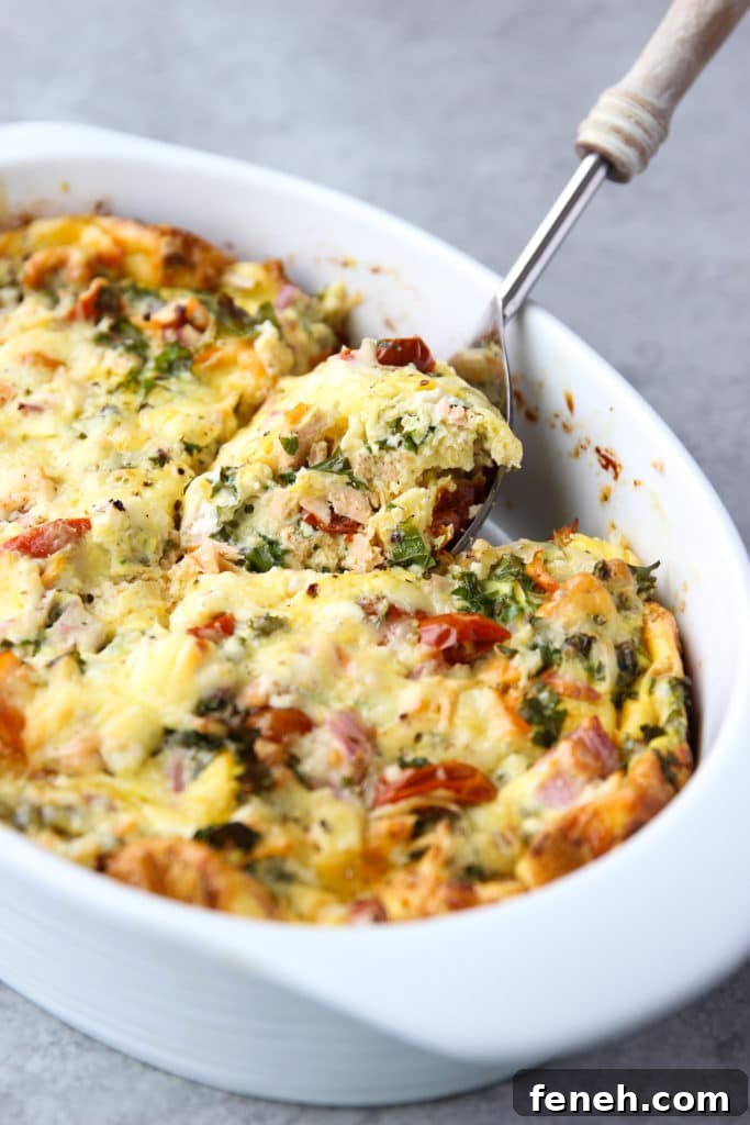 Smoked Salmon Breakfast Casserole with a serving spoon scooping a portion