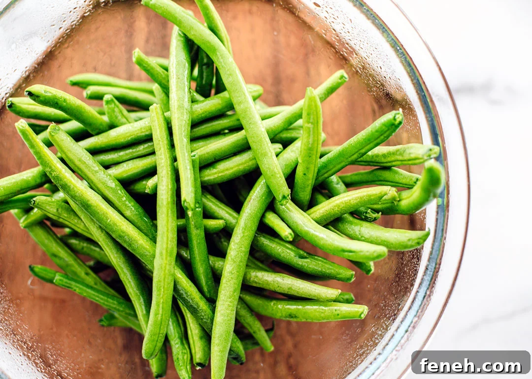 Glass bowl full of fresh green beans.