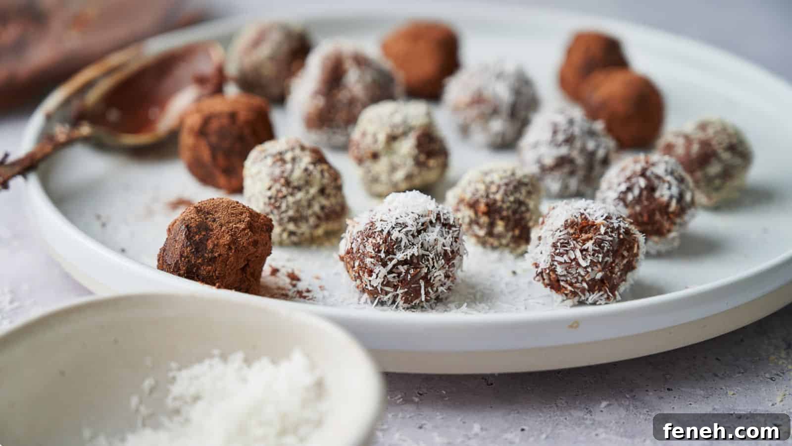 Chocolate truffles on a plate with a chocolatey spoon resting on the plate.