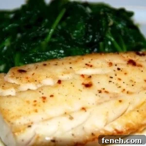 Paleo and Whole30 easy sous vide wild alaskan cod on a plate with steamed spinach.