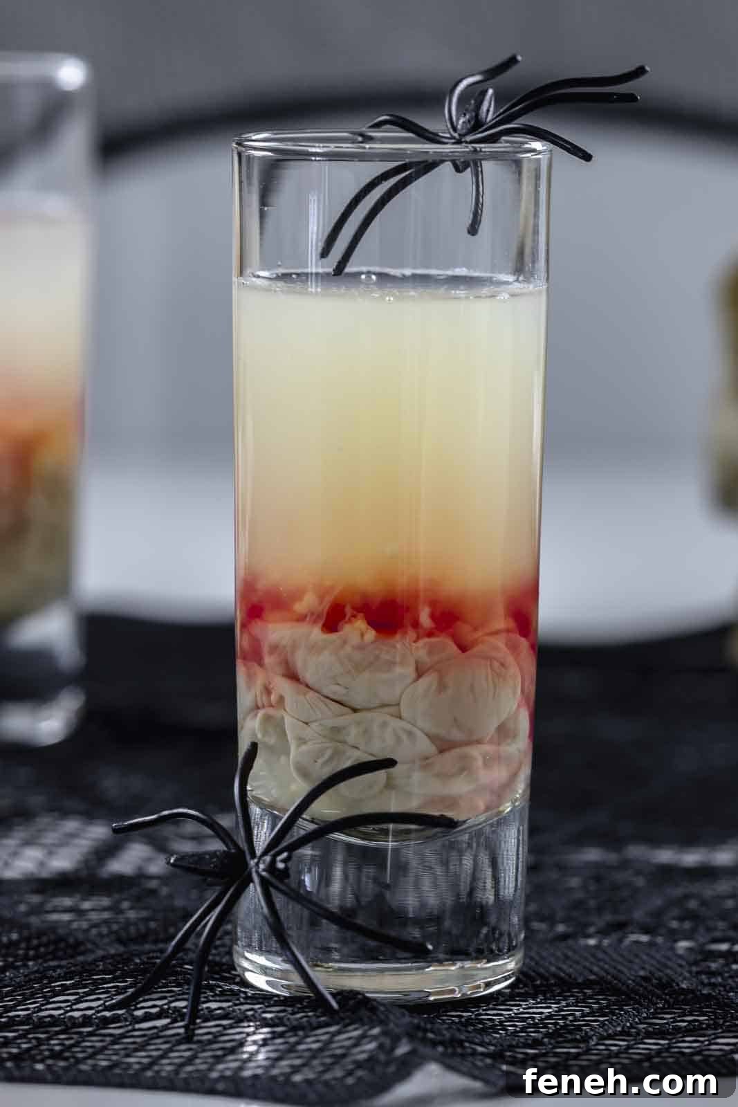 Halloween Shot Recipes and Spooky Shooter Ideas for Parties 3 Halloween themed shooter with spider decorations.