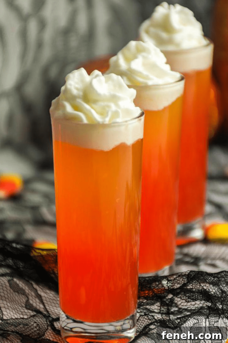 Halloween Shot Recipes and Spooky Shooter Ideas for Parties 7 Orange candy corn theme shooters with whipped cream.