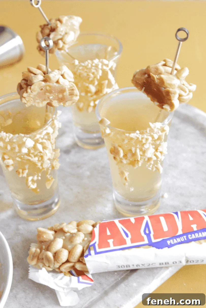 Halloween Shot Recipes and Spooky Shooter Ideas for Parties 8 Candy themed vodka shooters with peanuts on a serving tray.