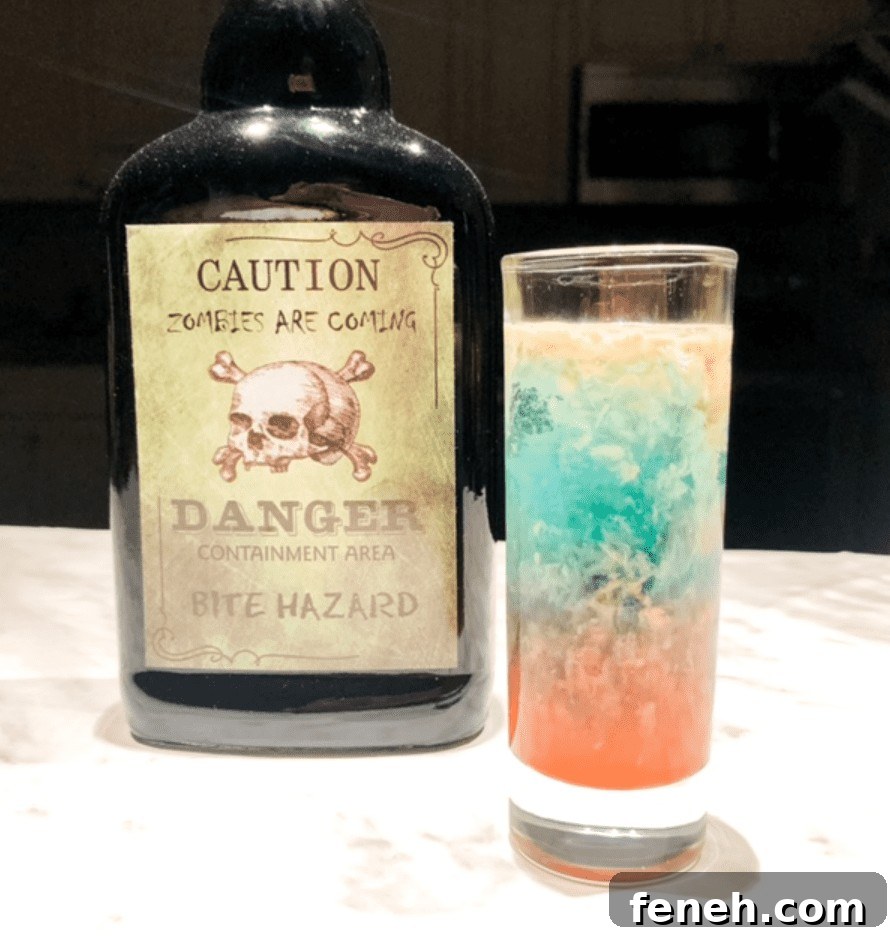 Halloween Shot Recipes and Spooky Shooter Ideas for Parties 10 Colorful shooter on table with zombie alcohol bottle.