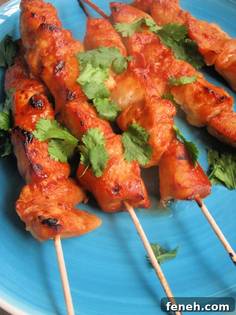 sweet and spicy chicken kebabs on a blue plate