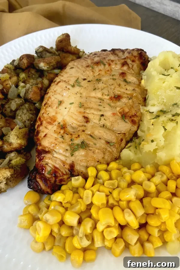 turkey tenderloin on plate with thanksgiving side dishes 