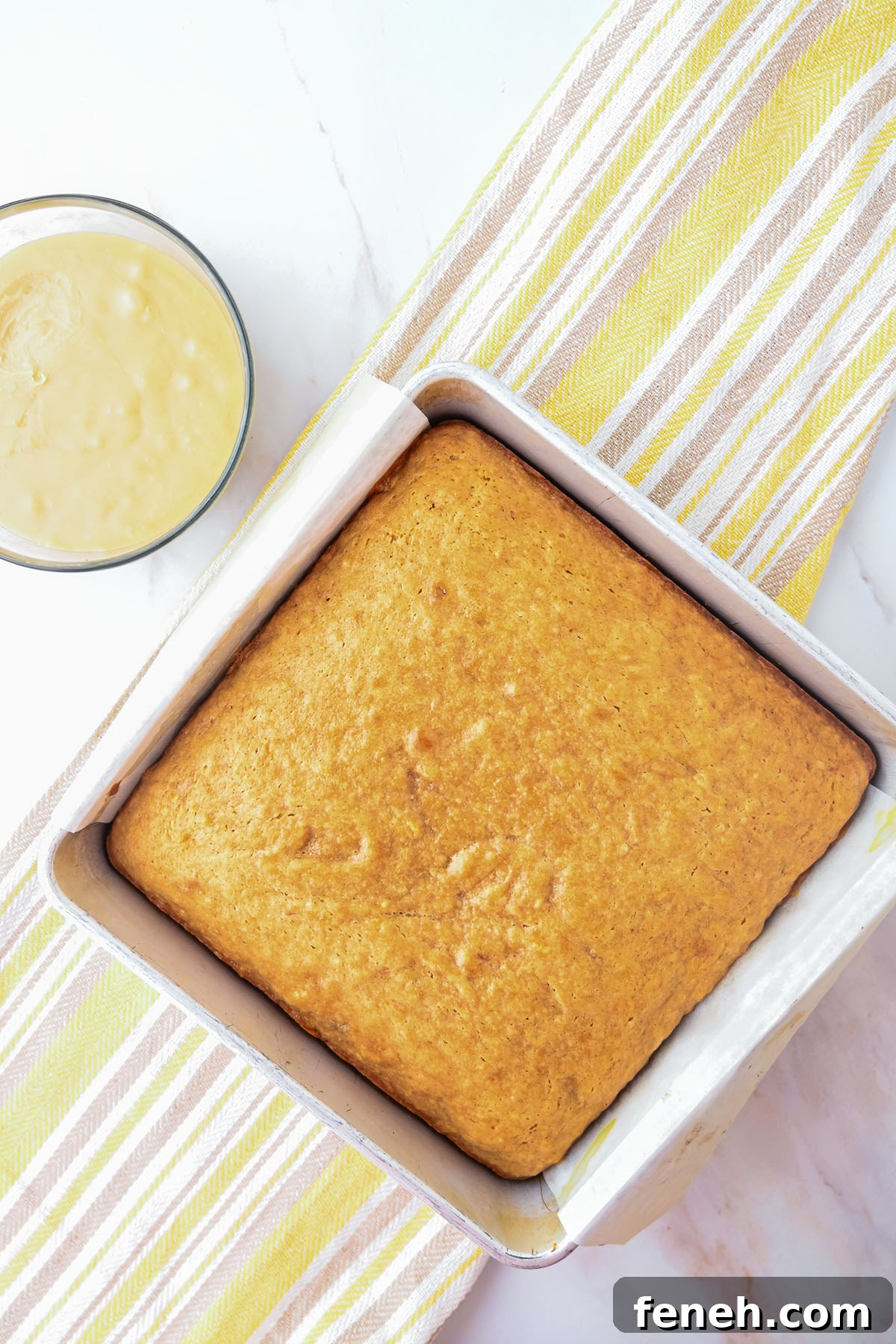 Baked Banana Blondies in parchment paper lined square baking pan.