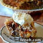 slice of cream of coconut pecan pie on white plate