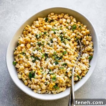 easy elote dip in a bowl with a silver spoon and cilantro on top