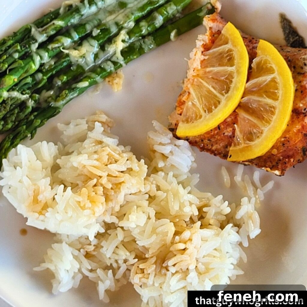 Grilled Salmon in foil packet served with white rice and cheesy asparagus